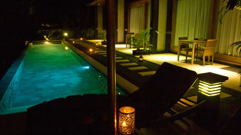 The outdoor and pool area of The Puncak at night