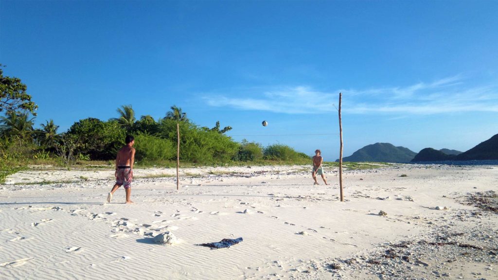 Guests playing beach volleyball on Dimancal Island in Linapacan