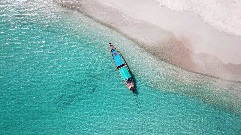 Longtail boat shot with a drone on Bottle Beach