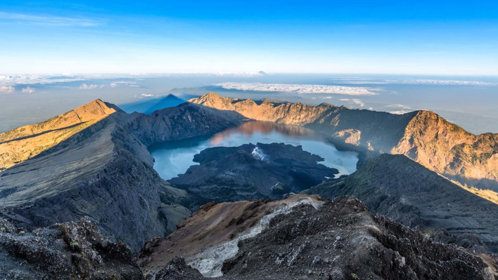 View from the summit of Mount Rinjani to the crater lake Segara Anak and Bali