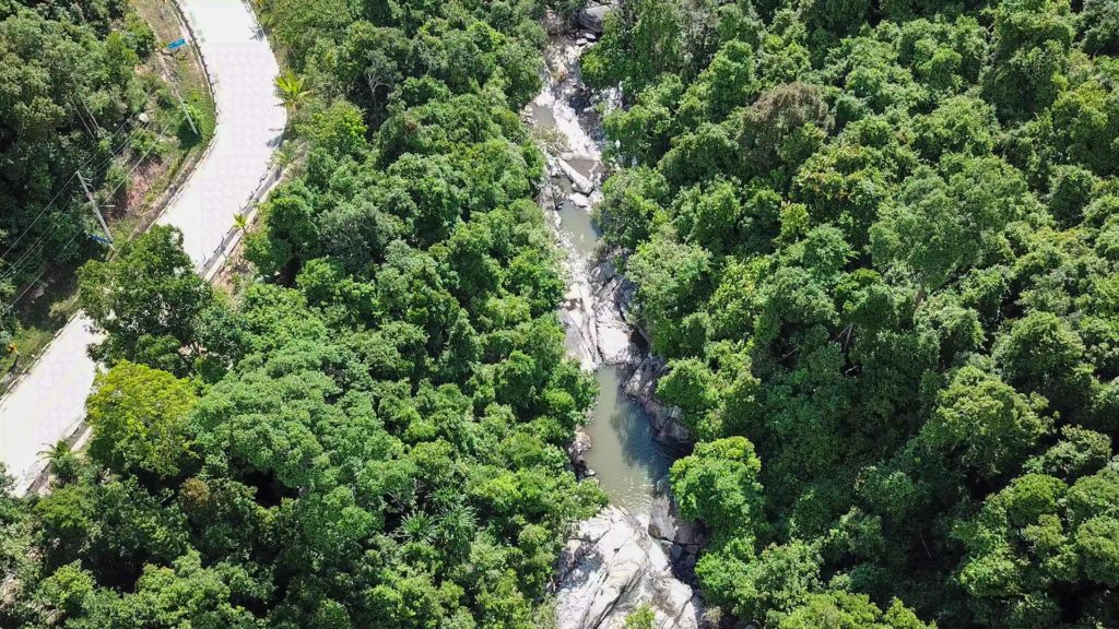 Road in the National Park and the Than Sadet waterfall, shots taken by drone 