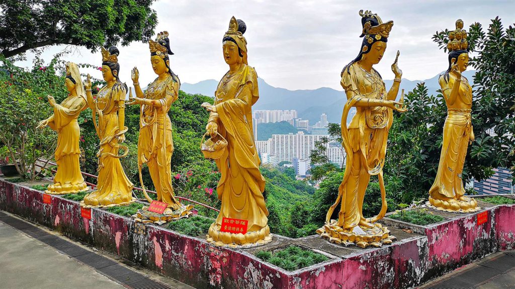 Buddhist statues with a view of the Hong Kong skyline